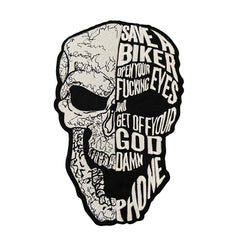 Skull-shaped sticker with text on a dark background