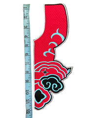 Red and blue decorative item with cloud designs on a gray background, measured by a ruler.