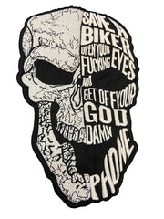 Skull-shaped patch with text on a gray background