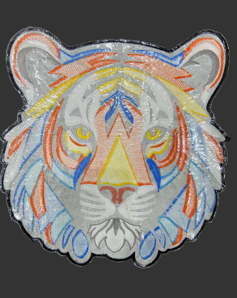 Decorative patch with colorful geometric design on a dark background