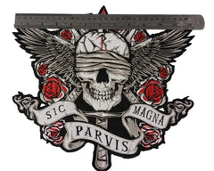 Skull with roses and wings on a concrete wall with 'Sic Parvis Magna' text.