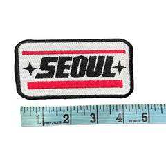 Embroidered patch with 'SEOUL' text and a ruler for scale on a gray background