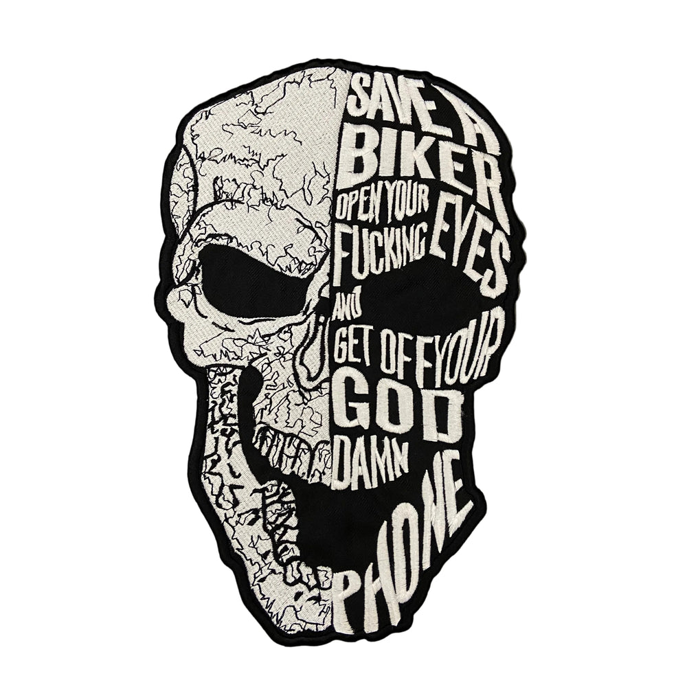 Skull-shaped sticker with text on a dark background