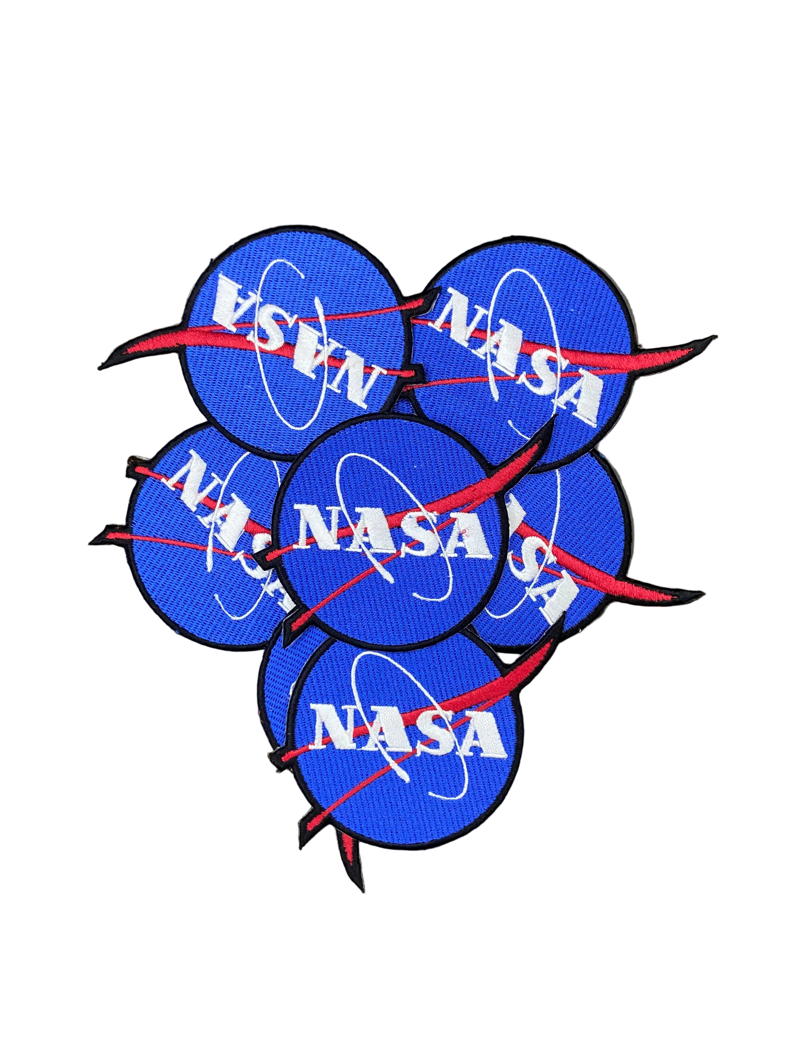 Multiple NASA patches on a white background
