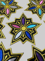 Decorative patches with colorful floral designs on a textured surface