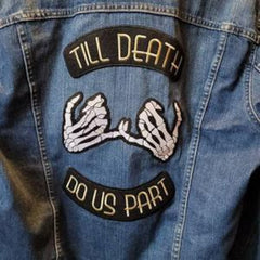 Denim jacket with skeleton hands and 'Till Death Do Us Part' patches.