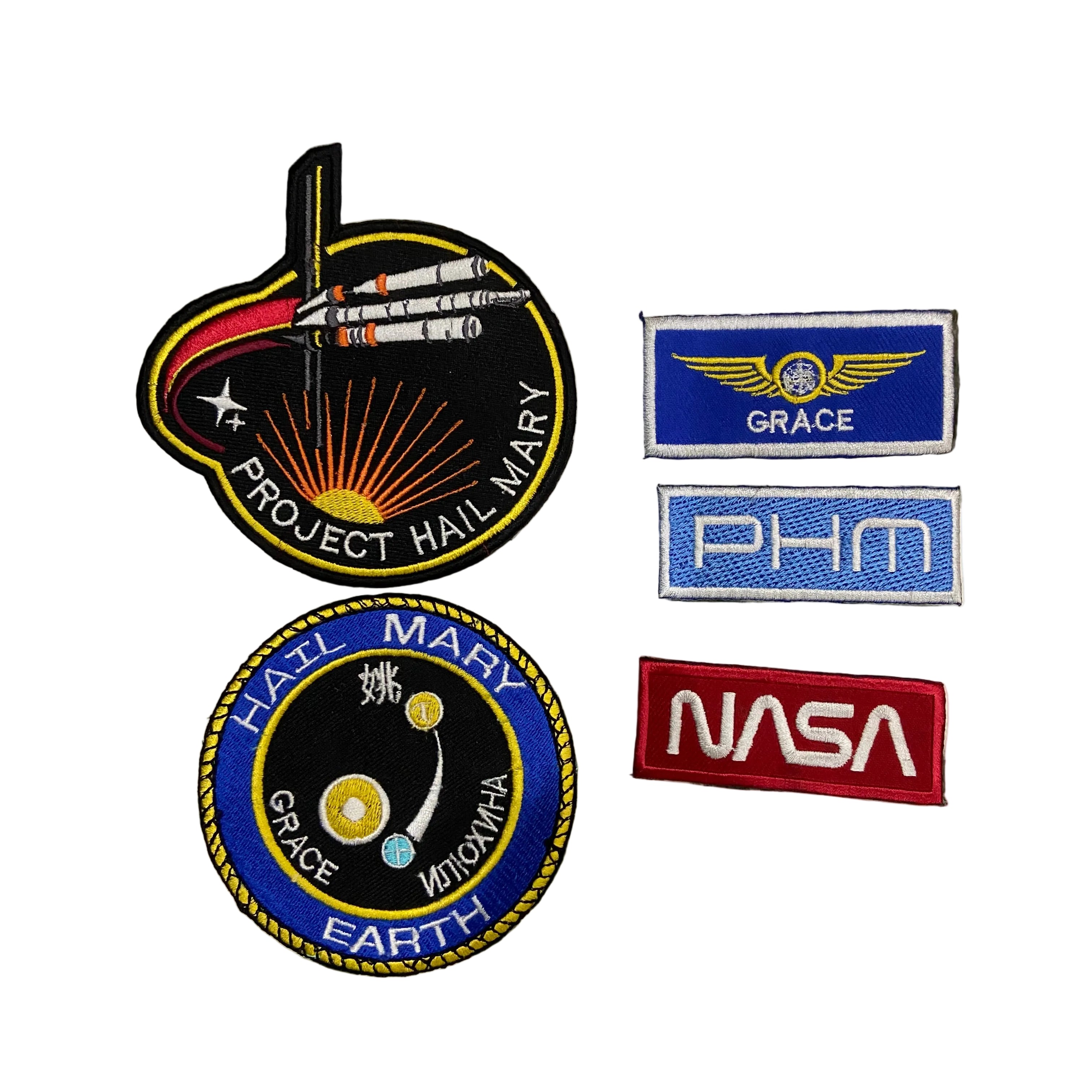 Collection of space-themed patches including 'NASA' and 'Project Hail Mary'.