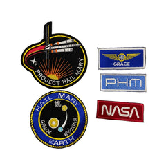 Collection of space-themed patches including 'NASA' and 'Project Hail Mary'.